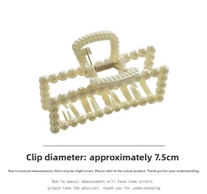 Detail view of a 7.5cm cream pearl hair claw clip with rectangular hollow structure