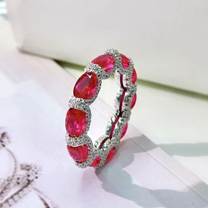 Detailed close-up of 925 silver ring with oval red rubies and pavé diamond accents