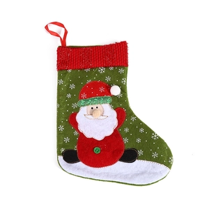 Christmas stocking with 3D Santa Claus figure and white snowflake patterns on green felt