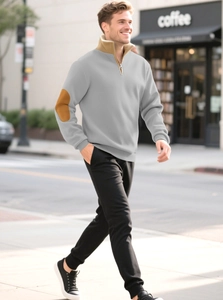 Detail of grey men's quarter-zip sweatshirt featuring vintage brown faux suede elbow patches