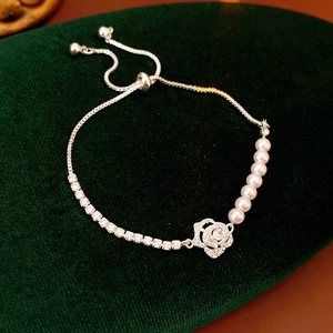 Detail of adjustable flower bracelet with high-luster pearls and sparkling zircons