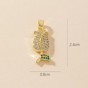 Macro shot of gold rose pendant with clear crystals and green leaf stones measuring 2.4cm
