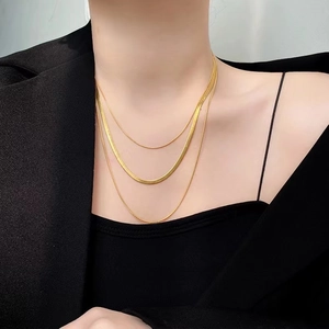 Three-layer gold snake bone necklace for women featuring a stylish geometric layered design