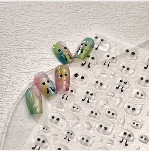 Detail of 3D ghost nail art stickers with cute cartoon patterns and glitter gradients