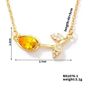Detail showing gold tulip pendant with yellow pear-cut zircon and white stone pave