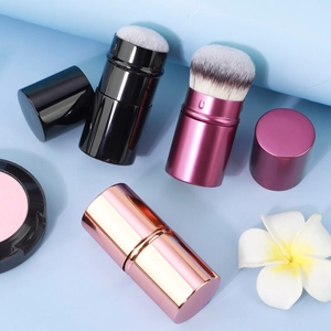 Detail view of the portable retractable makeup brushes with dense fiber bristles and metal caps