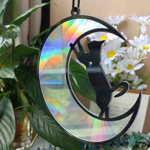 Detail of crescent moon suncatcher with black cat silhouette and iridescent rainbow panels