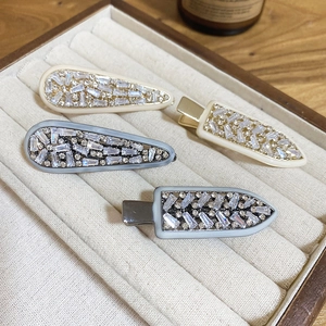 Elegant 4-piece cubic zirconia hair clip set in white and blue on a velvet box