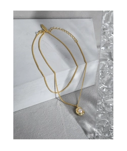 Detailed macro view of S925 silver shell pearl pendant with organic gold metal edges