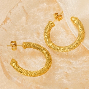 Detail of 18K gold-plated stainless steel twisted hoop earrings with elegant texture