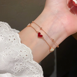Double-layer rose gold bracelet with red enamel and white mother of pearl heart charms
