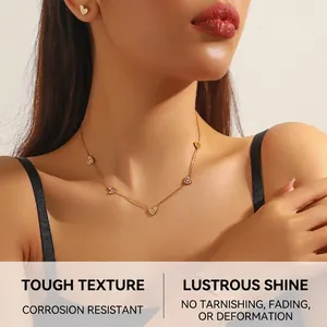 Detailed view of elegant gold heart necklace and earrings with white pearl shell inlay