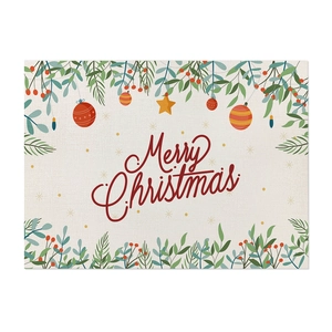 Detail of Christmas placemat with botanical print and Merry Christmas text on linen texture
