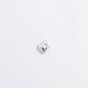 Close-up of polished silver S925 heart pendant charm with attachment ring for DIY jewelry