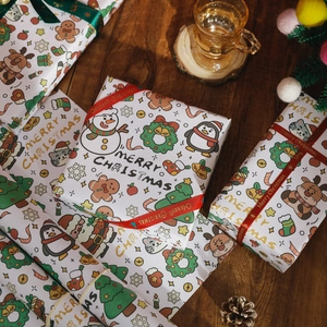 Vintage Christmas wrapping paper set with snowman patterns and matching red ribbon