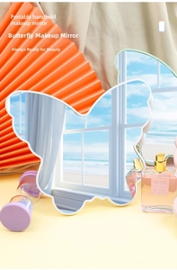 Detail of white butterfly-shaped desktop makeup mirror with high-definition glass surface