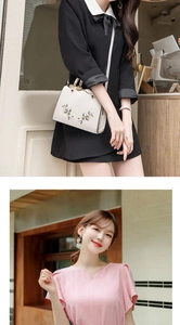 Detail of white handbag with floral embroidery paired with a pink V-neck chiffon blouse
