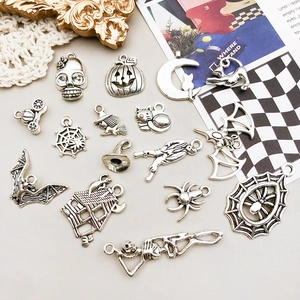 Detail of vintage silver Halloween charms including skulls, pumpkins, and spider webs