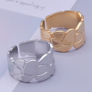 Detailed view of adjustable gold and silver rings with unique crushed stone texture