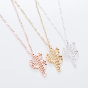Detailed view of hollow cactus pendant necklaces in rose gold, gold, and silver tones