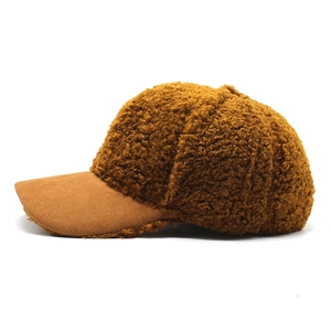 Detail of caramel brown teddy baseball cap with plush sherpa and suede brim