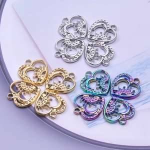 Detail of hollow heart pendants with sun and moon designs in gold silver and rainbow