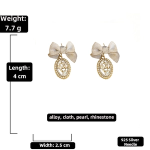 Detail view of champagne bow earrings with elegant pearls, rhinestones, and silver pins