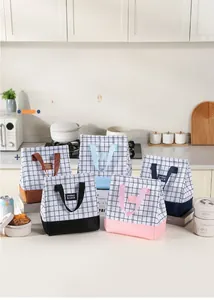 Detail of insulated plaid lunch bags in various colors made of high-density Oxford cloth