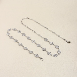 Close-up of silver metal waist chain featuring sparkling rhinestones and lobster clasp