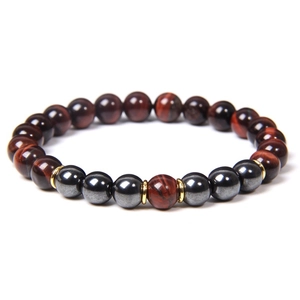 Macro shot of 8mm red tiger eye stones and dark hematite beads with gold spacers