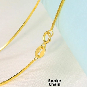 Macro shot of gold-plated S925 sterling silver square snake chain with spring clasp