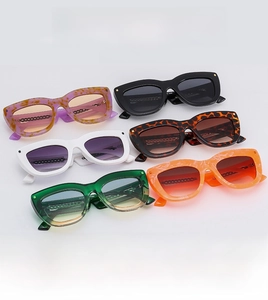 Detail view of cat-eye sunglasses in various colors with metallic chain temple design