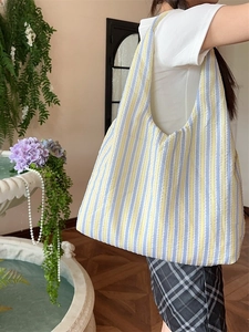 Minimalist dopamine yellow and blue striped canvas tote bag with a pleated fabric texture
