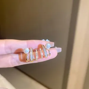 Elegant multi-layered gold hoop earrings with zircon studs and round white pearls