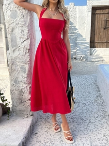 Detail of red halter-neck midi dress with elastic high waist and flowy skirt