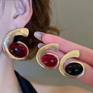 Retro gold spiral earrings with oval resin stones in deep red and black finishes
