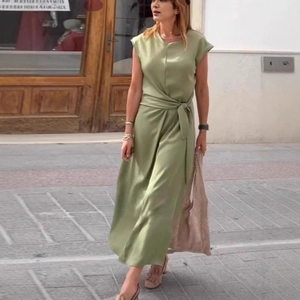 Detail of elegant avocado green midi dress showing waist tie design and soft fabric