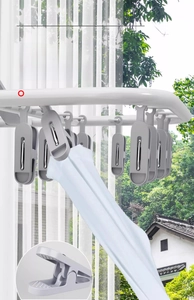 Close-up of non-slip clips on a white folding laundry rack for socks and underwear