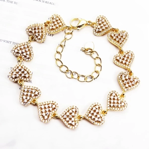 Elegant gold heart link bracelet with micro-p鑲 zircon stones on vintage paper background