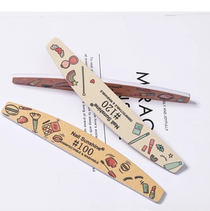 Detailed view of three beige double-sided nail files with cosmetic cartoon patterns
