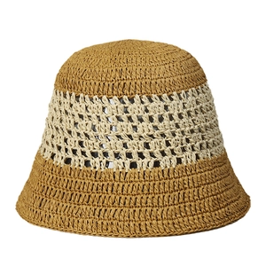 Handwoven straw bucket hat with a two-tone crochet pattern in brown and beige tones