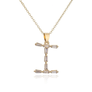 Close-up of 18K gold plated letter I pendant with sparkling cubic zirconia and reflection