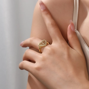 Detailed view of gold plated heart ring with hollow grid and sparkling zircon stones
