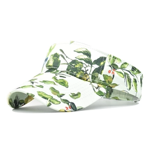 Detail of white sun visor with green leaves and red berries botanical pattern print