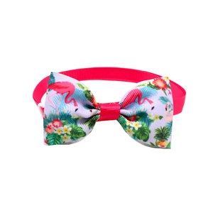 Detailed close-up of pink pet bowtie collar featuring tropical flamingo print pattern
