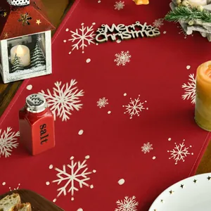 Festive red Christmas table runner with snowflake pattern and Merry Christmas text decor