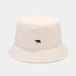 Close-up of brown bear embroidery on off-white cotton canvas bucket hat