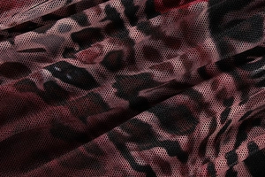 Vue macro du tissu en maille respirant à imprimé léopard avec dégradé de rouge et noir