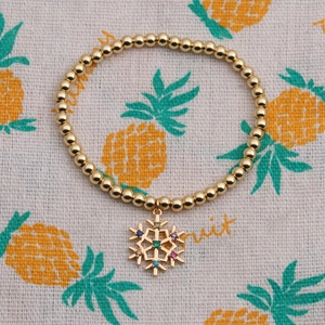Bracelet élastique à perles dorées avec pendentif flocon de neige en pierres colorées