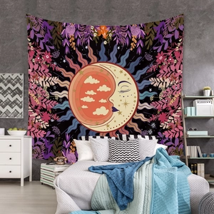 Detail of bohemian sun and moon tapestry with floral patterns hanging on bedroom wall